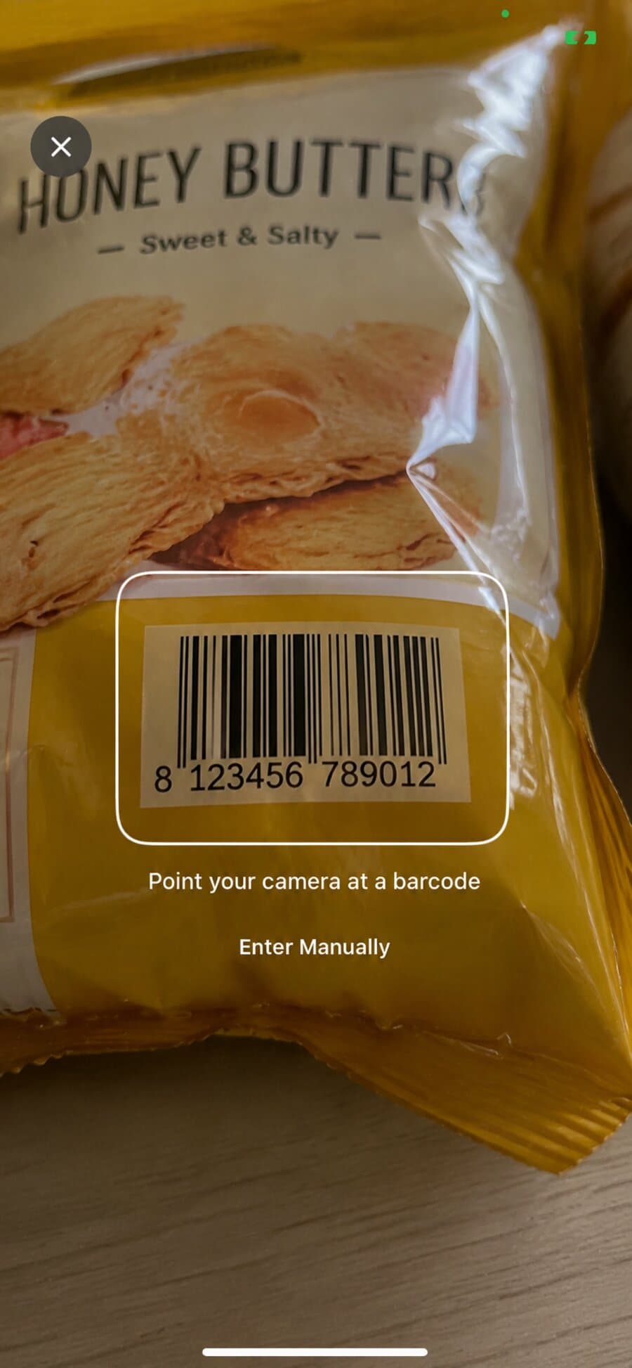 PlateScan barcode scanner pointed at a packaged snack, with the barcode framed and detected